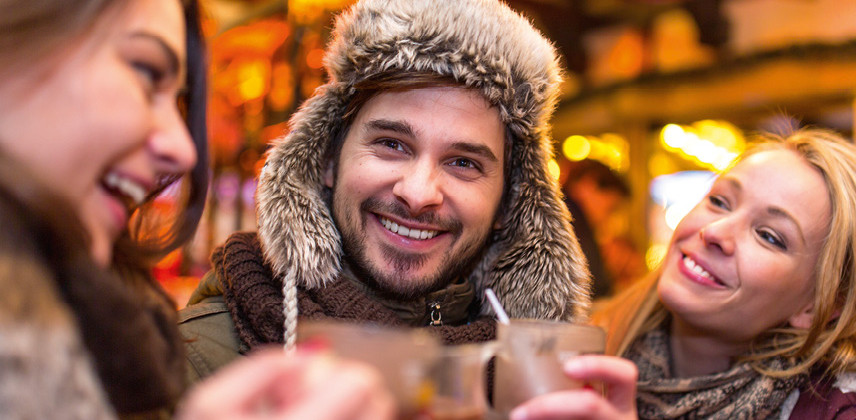 Ein Mann und zwei Frauen trinken heiße Schokolade